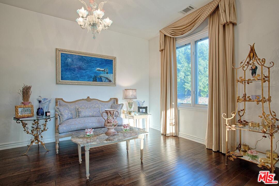 423 Woodbluff Road Monte Nido, CA 91302 - Photo 18 of 31 a living room with furniture a table and wooden floor