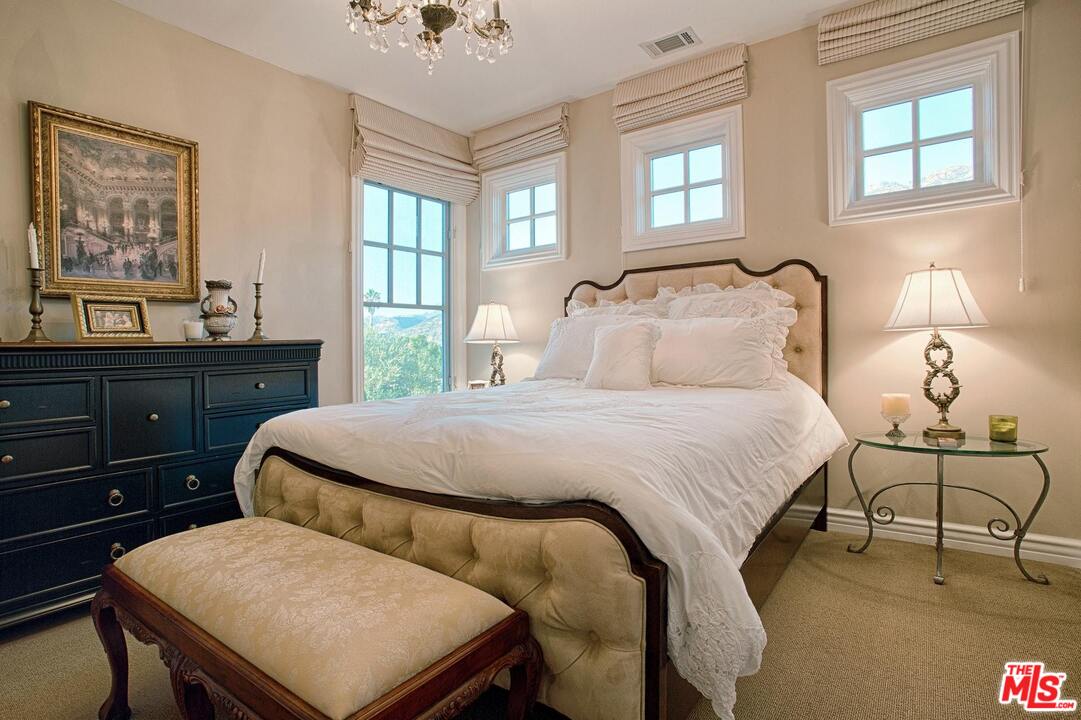 423 Woodbluff Road Monte Nido, CA 91302 - Photo 20 of 31 a bedroom with a bed and window