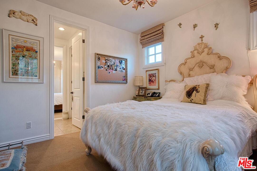 423 Woodbluff Road Monte Nido, CA 91302 - Photo 21 of 31 a bedroom with a bed and a window