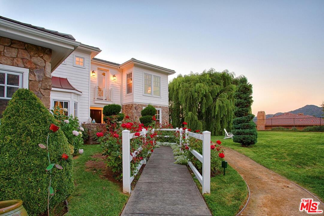 423 Woodbluff Road Monte Nido, CA 91302 - Photo 5 of 31 a house view with a garden space