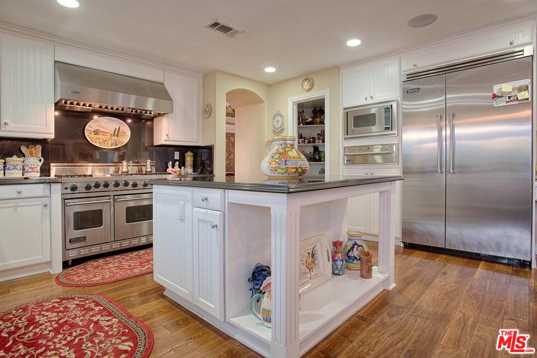 423 Woodbluff Road Monte Nido, CA 91302 - Photo 9 of 31 a kitchen with stainless steel appliances granite countertop a stove and cabinets