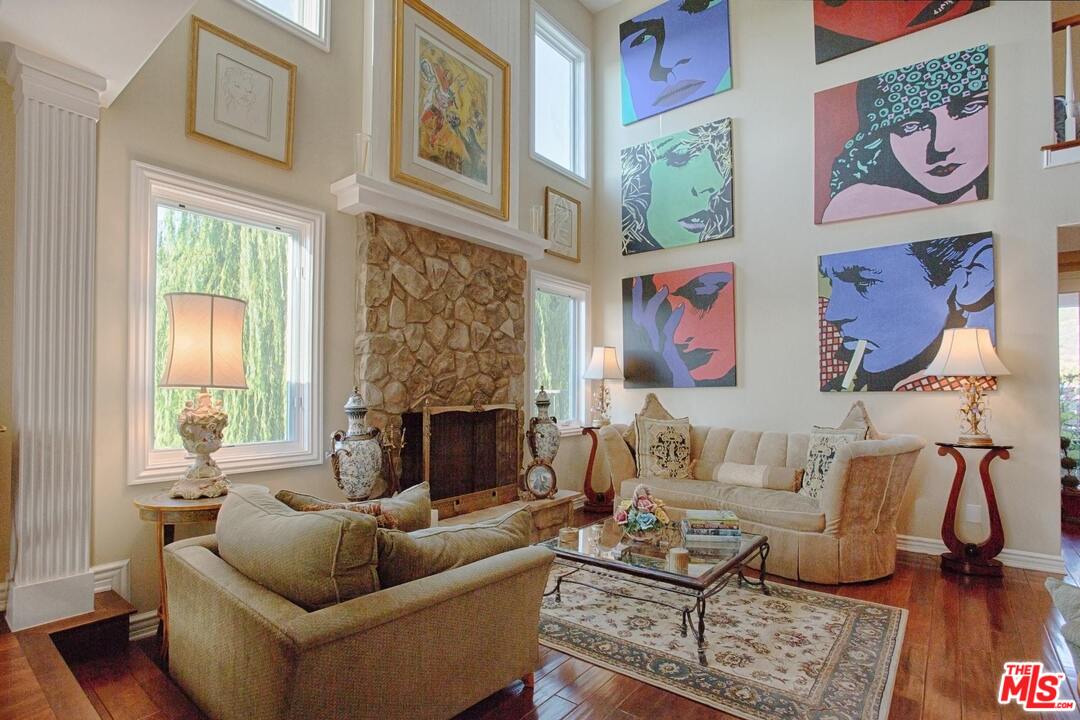 423 Woodbluff Road Monte Nido, CA 91302 - Photo 10 of 31 a living room with furniture and a fireplace