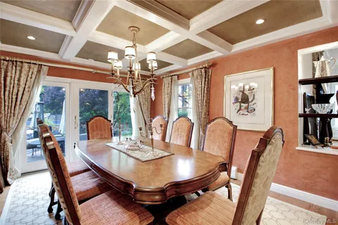 a view of a dining room with furniture chandelier and wooden floor