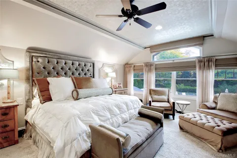 a bedroom with a bed couch and window