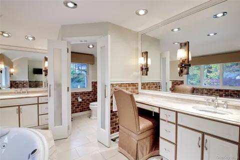 a spacious bathroom with a sink double vanity and a mirror