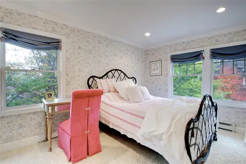 a bedroom with a bed and windows