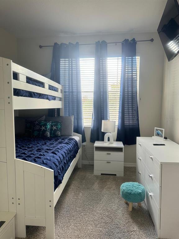 326 Chelsea Drive Davenport, FL 33897 - Photo 17 of 20 a bedroom with a bed and a dresser