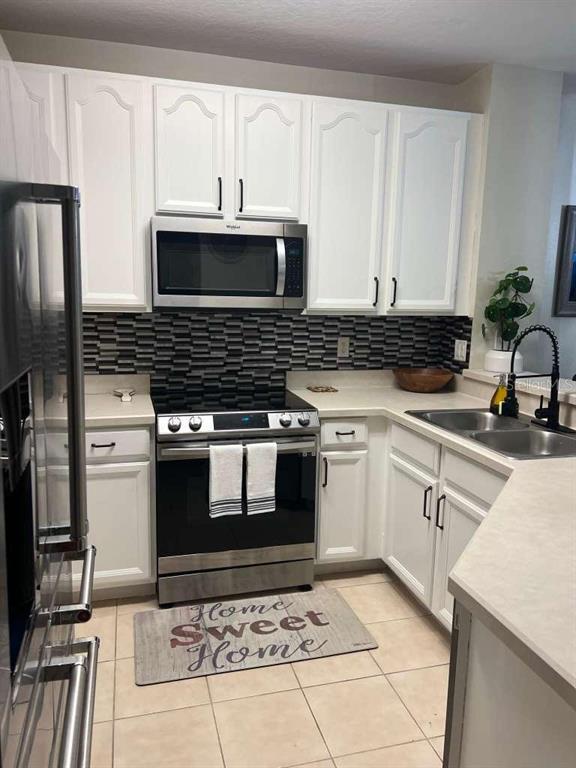 326 Chelsea Drive Davenport, FL 33897 - Photo 6 of 20 a kitchen with granite countertop a stove and a sink