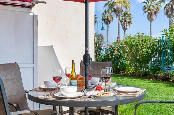 a view of a chair and table in the backyard
