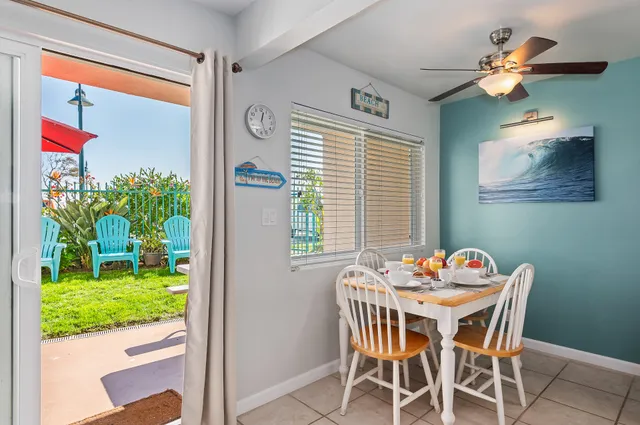 a dining room with furniture and a potted plant