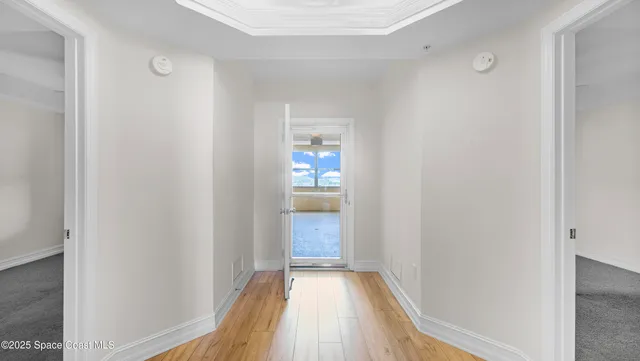 a view of hallway with wooden floor
