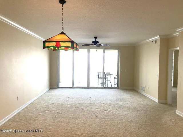 a view of room with window and chandelier