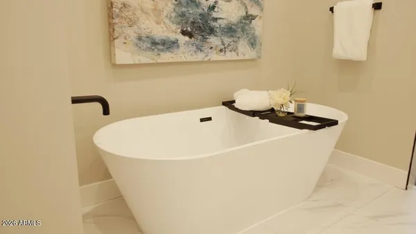a white bath tub sitting next to a white sink