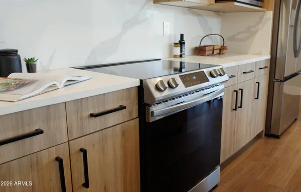 a kitchen with a refrigerator and a stove