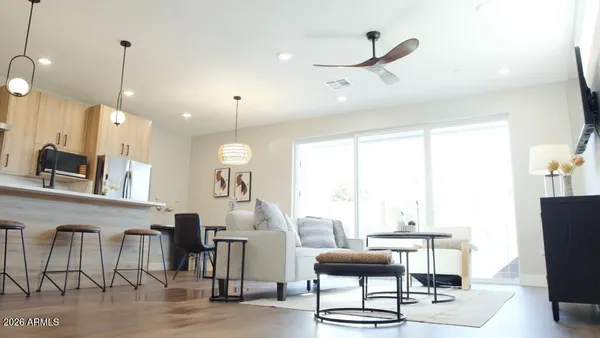 a living room with furniture a rug and white walls