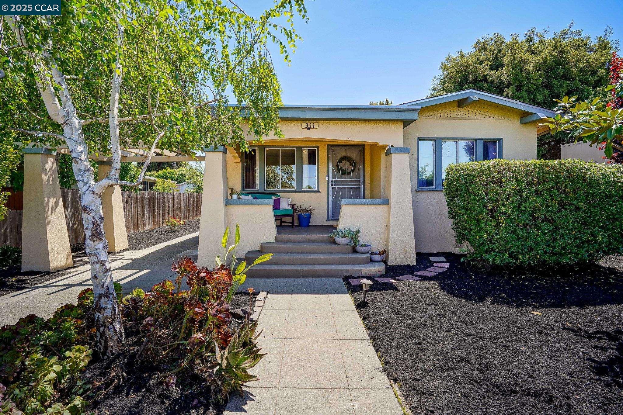 311 Railroad Avenue Rodeo, CA 94572 - Photo 1 of 1 a front view of a house with garden