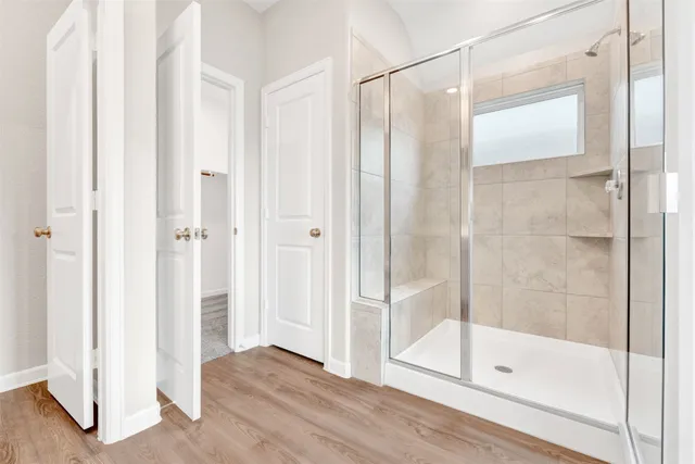 a bathroom with a glass shower door