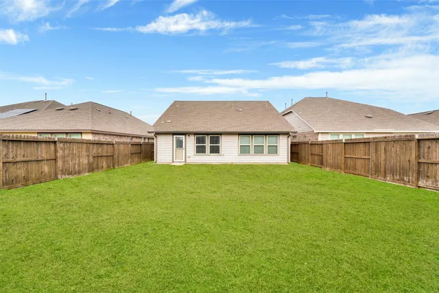 a view of house with yard and ocean view