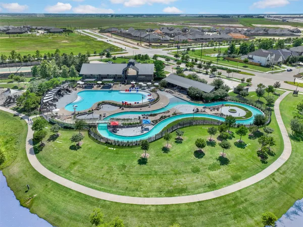 a view of a swimming pool with a yard and mountain