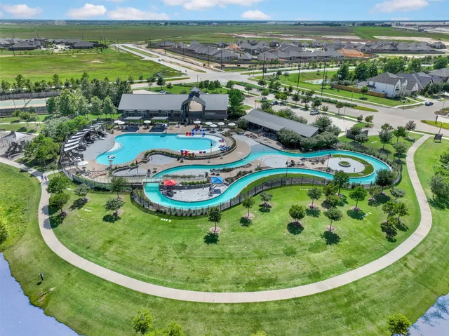 a view of a swimming pool with a yard and mountain