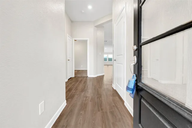 a view of hallway with wooden floor