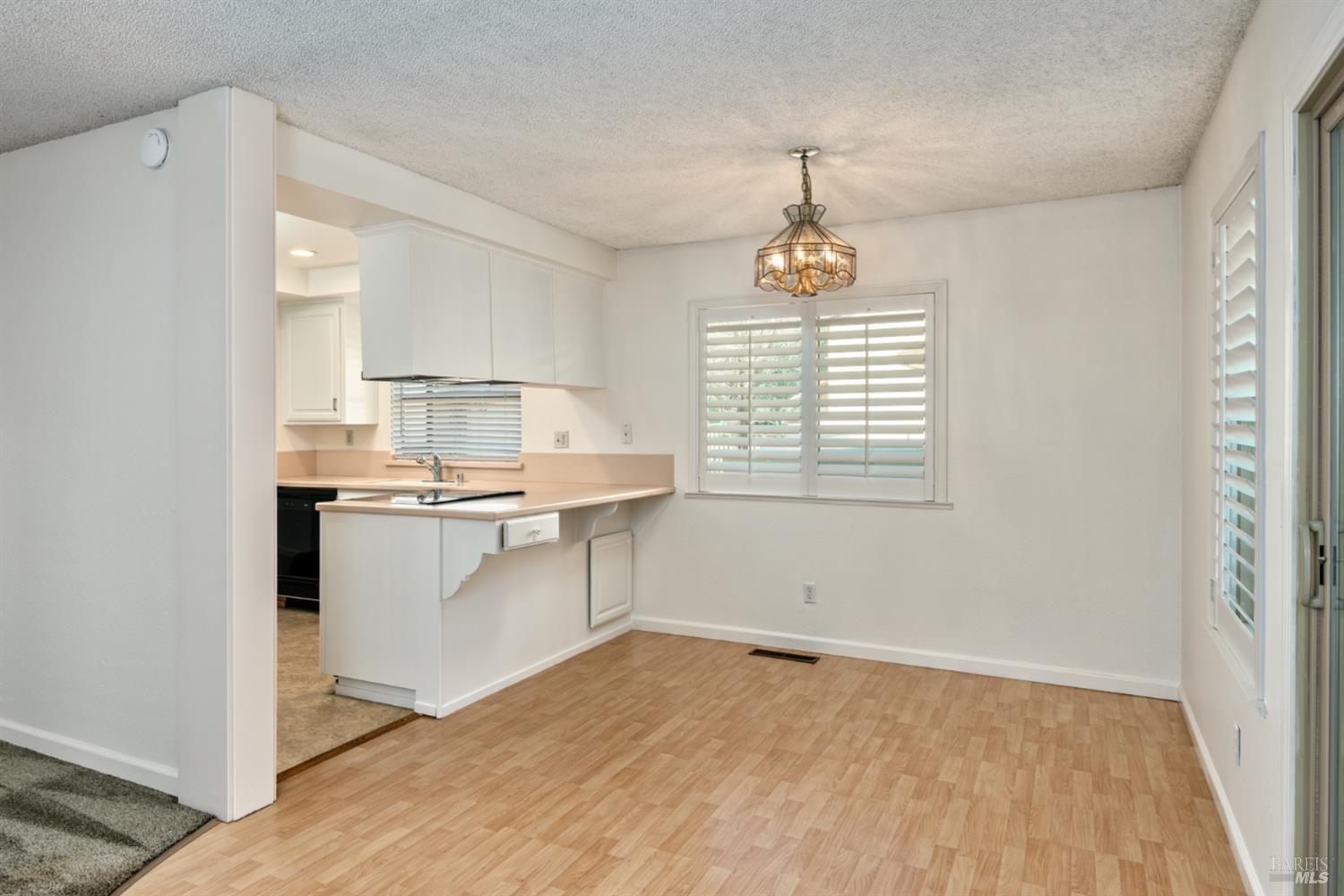 826 Adobe Drive Santa Rosa, CA 95404 - Photo 12 of 32 a kitchen with kitchen island granite countertop a sink cabinets and wooden floor