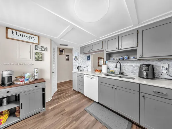 a kitchen with stainless steel appliances granite countertop a sink and cabinets