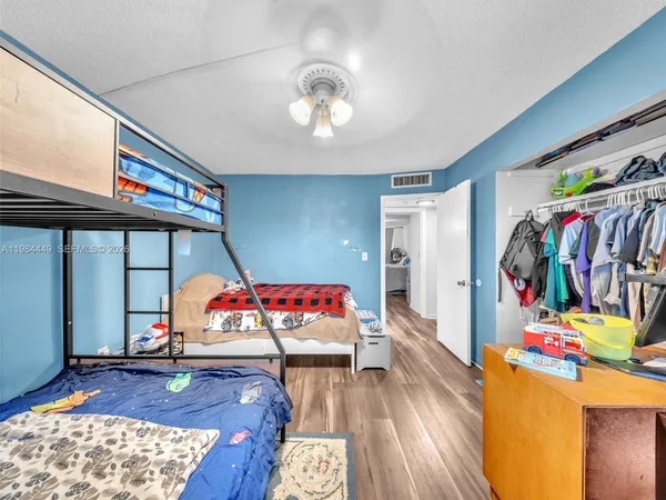 a bedroom with furniture and a wooden floor