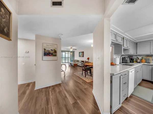 a kitchen with cabinets and wooden floor