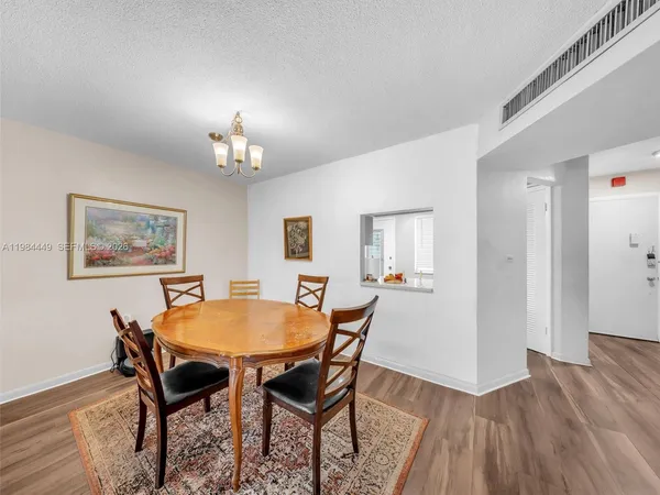 a dining room with furniture and wooden floor