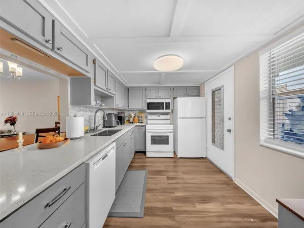 a kitchen with stainless steel appliances a refrigerator sink and cabinets