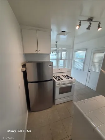 a kitchen with a stove a refrigerator and a sink