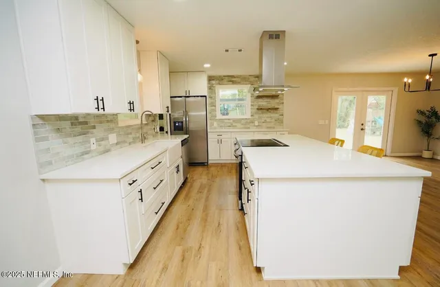 a kitchen with sink a stove and refrigerator