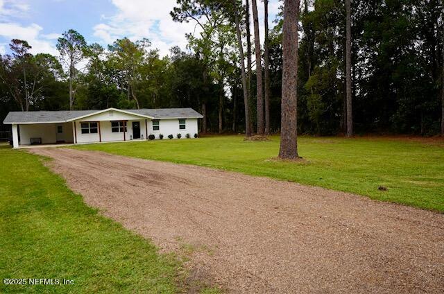 54376 Lisa Drive Callahan, FL 32011 - Photo 2 of 32 a front view of a house with a yard and trees