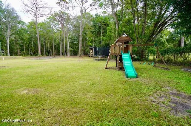 a backyard of a house with childrens swings and slides