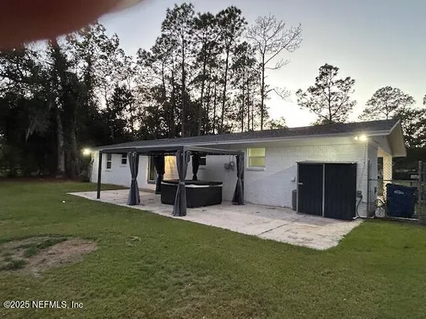 a view of a house with a yard and sitting area