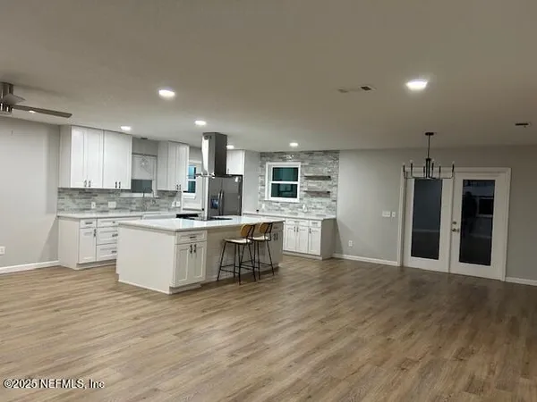 a kitchen with a refrigerator and a sink
