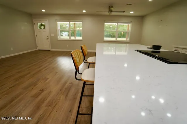 a workspace with wooden floor and windows