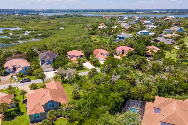an aerial view of residential houses with outdoor space and swimming pool