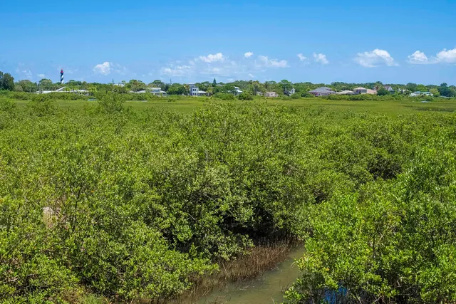 a view of a sign board with a garden