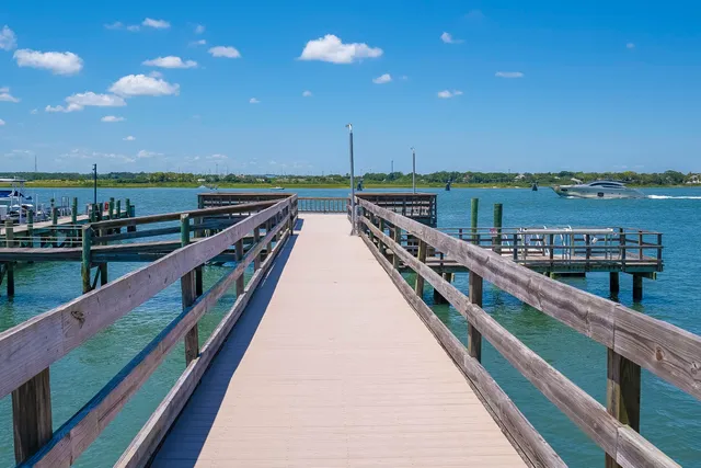 a view of a lake with houses in the back
