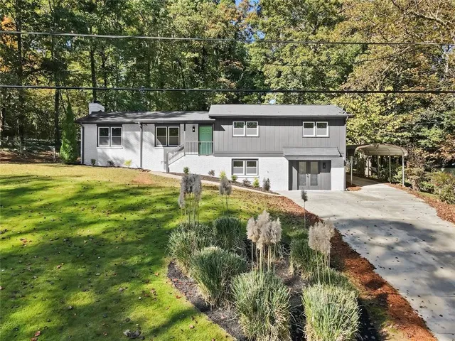 a house view with a sitting space and garden