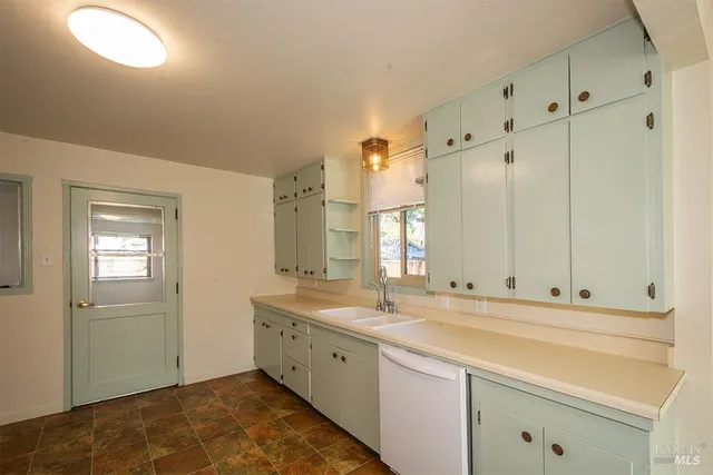 a spacious bathroom with double sink and a mirror
