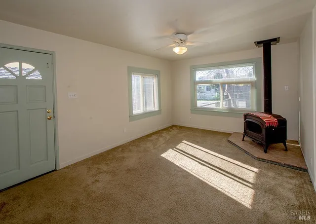 a spacious bedroom with a bed and a window
