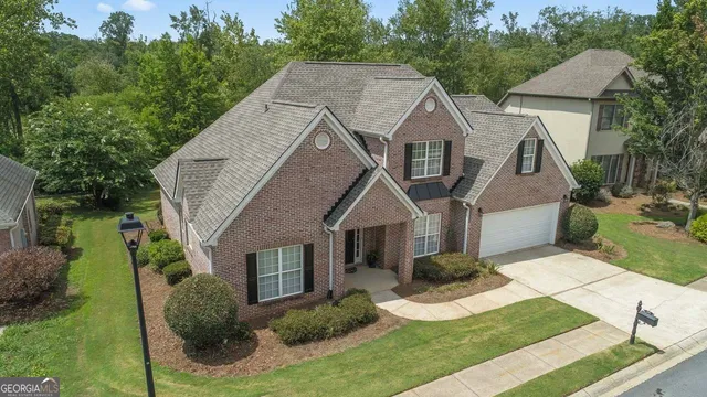 a aerial view of a house next to a yard