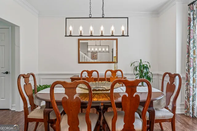 a view of a dining room with furniture and chandelier