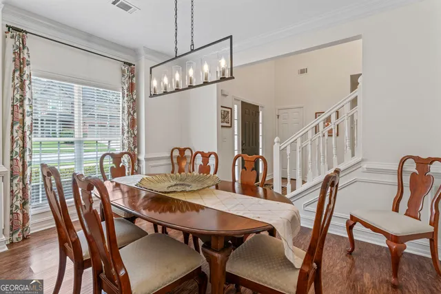 a view of a dining room with furniture window and wooden floor
