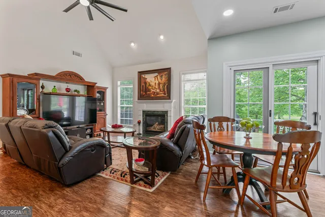 a living room with fireplace furniture and a flat screen tv