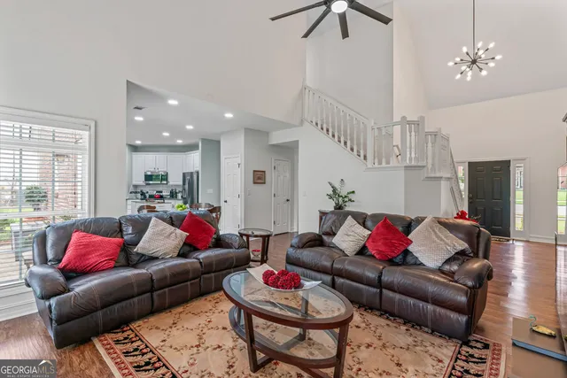 a living room with furniture and a chandelier