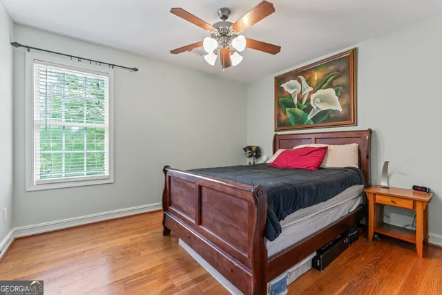 a bed sitting in a bedroom next to a window